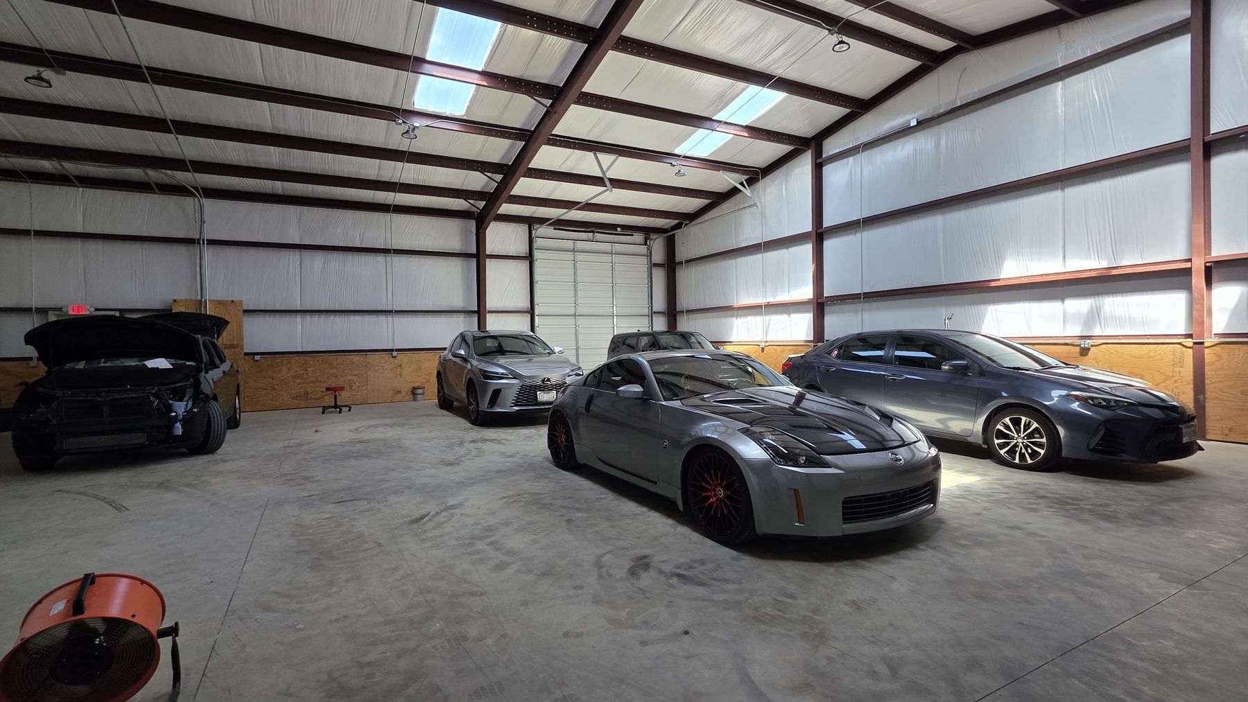 Pushing Metal shop interior, full bay with multiple vehicles